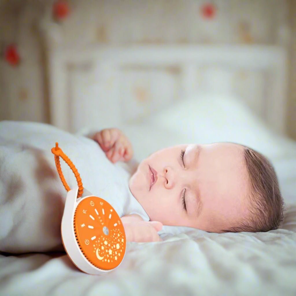 machine bruit blanc bebe orange pres de bebe